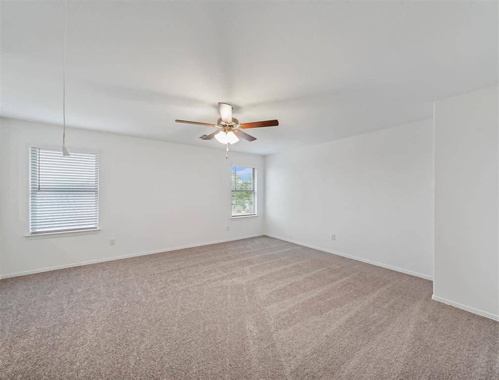 An additional view of the Spacious Game Room featuring natural lighting from windows and ample space to enjoy game time with friends or family.