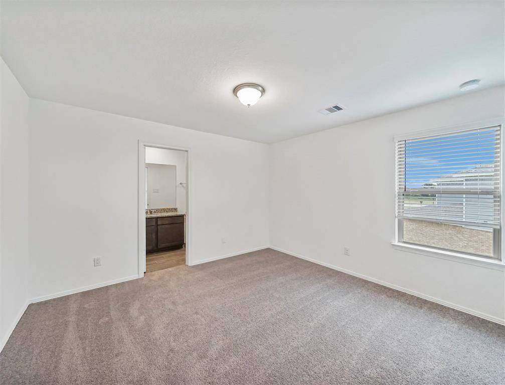 Secondary Bedroom that overlooks the beautiful neighborhood with plush carpet, closet for your wardrobe and attached Secondary Bath!