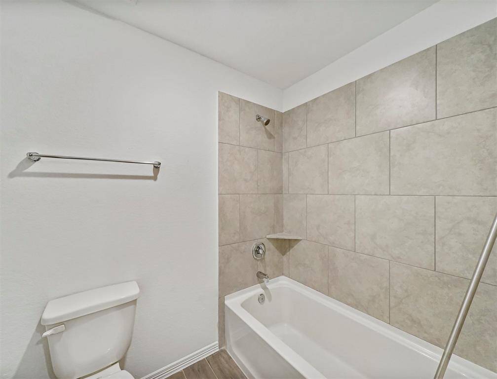Secondary Bathroom features a Beautiful shower/tub combo with tile surround, a perfect place to relax after a long day.