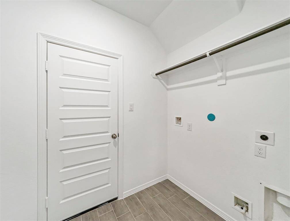 Incredible In-House Utility Room featuring terrific tile flooring and enormous amounts of storage space to ensure your laundry day is a breeze!