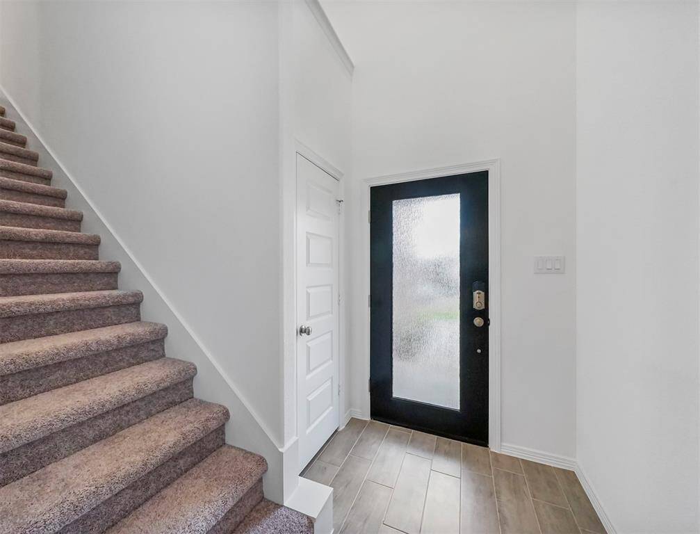 Terrific Tile Flooring, Staircase with plush carpeting, and Custom Front Door greet you upon immediate entry into this never lived in home ready for it's first family!