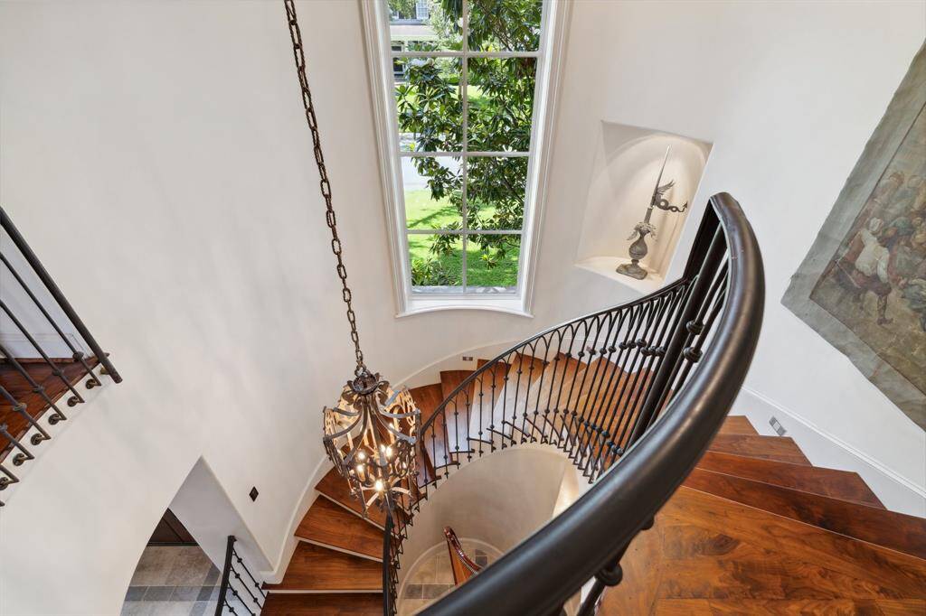Luxurious circular stairwell that sets the tone.