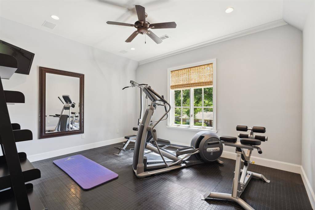 The fourth bedroom is currently being used as an exercise room. The room features an ensuite bath with marble countertops and a walk-in closet.