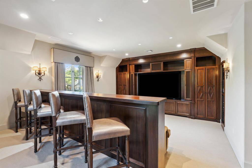 The fifth bedroom is currently the Media Room. The space features a Built-in entertainment center, wet bar and ensuite bathroom.