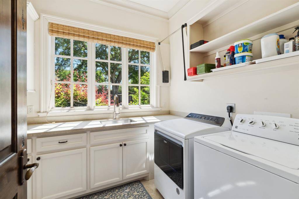 The mud room is located downstairs and includes a deep stainless steel sink and plenty of counterspace.