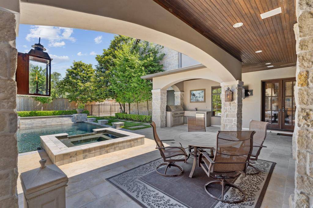 The remarkable outdoor patio includes a built in grill area.