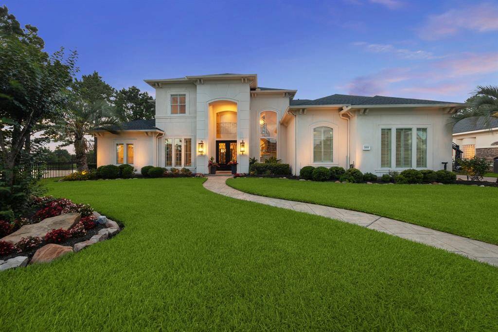 This beautifully appointed custom residence makes a lasting first impression with timeless architecture, lush landscaping, and tranquil lake views surrounding the property.