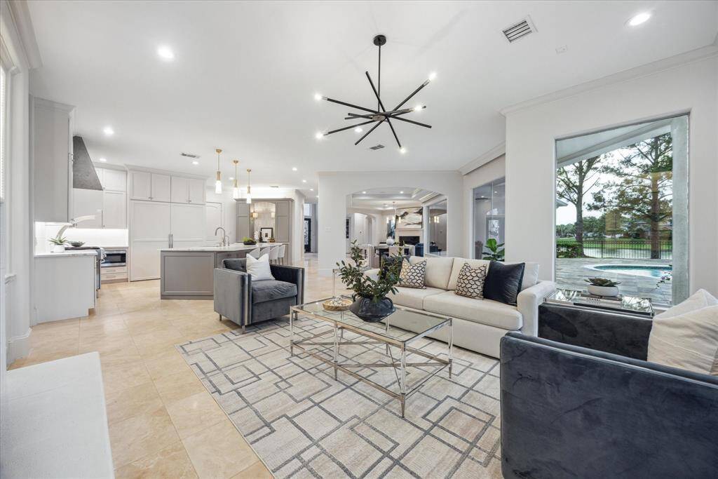 Expansive windows in the family room frame stunning lake views.