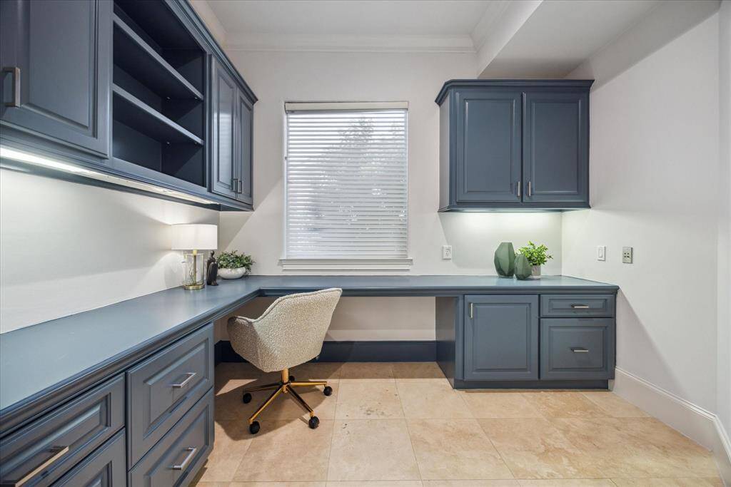 Just off the kitchen, this custom home office features built-in cabinetry. Conveniently located near the mudroom and second staircase.