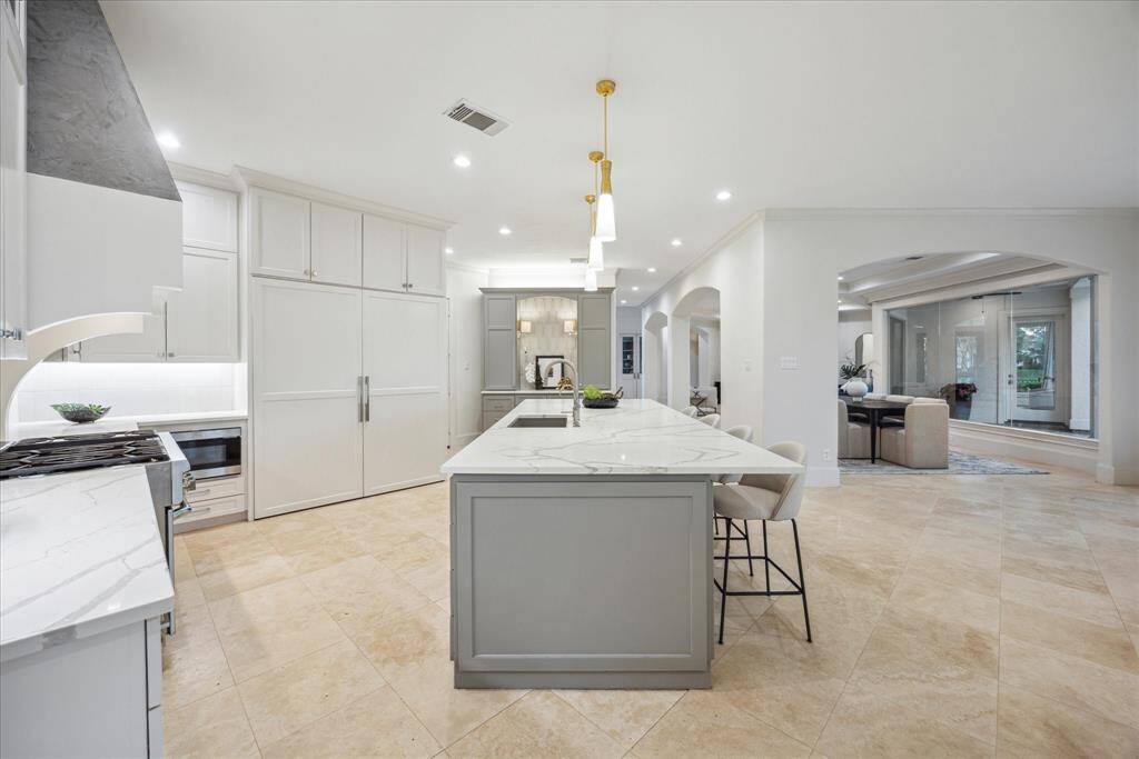 This chef’s kitchen features a panel-ready refrigerator seamlessly integrated with custom cabinetry for a sleek look.