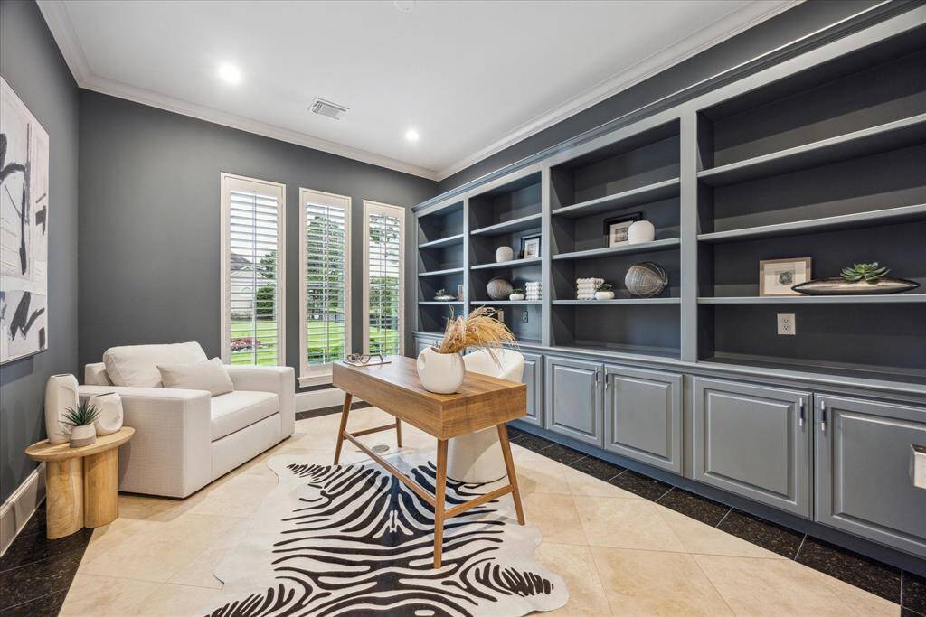 The dedicated study offers a quiet retreat with custom cabinetry painted in an accent tone, built-in shelving, and high-end leather and brass hardware.