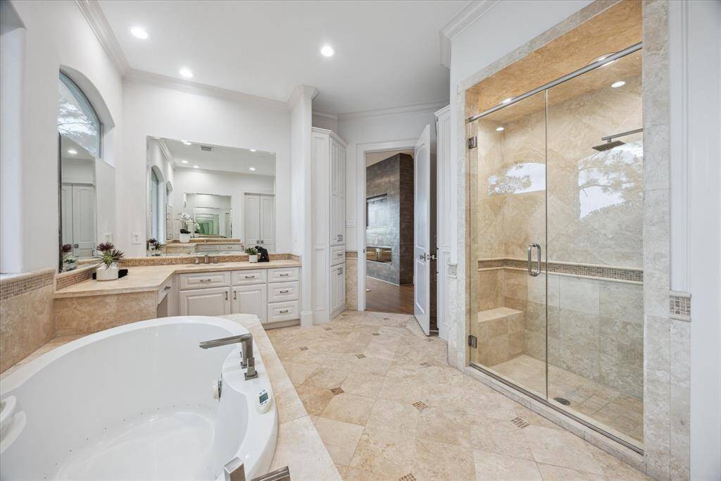Dual vanities with quartz countertops, a spacious layout, and elegant finishes create a true spa-like experience.