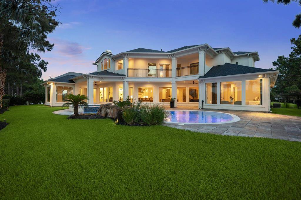 Enjoy year-round relaxation in this private oasis featuring a sparkling pool, elevated spa, and covered veranda—all set against a backdrop of sweeping lake views.