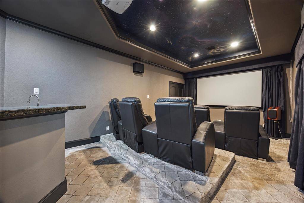 Designed for the ultimate movie night or game-day experience, the media room features tiered seating, custom lighting, and a built-in wet bar for added convenience.