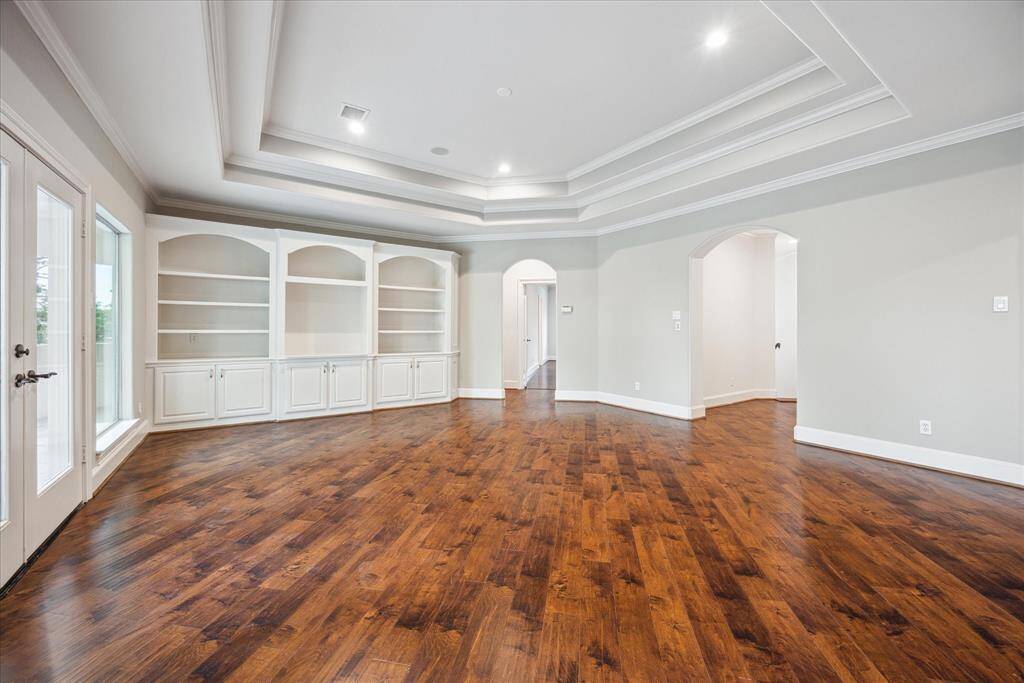 As you exit the media room, the second-floor landing guides you to three spacious secondary bedrooms.