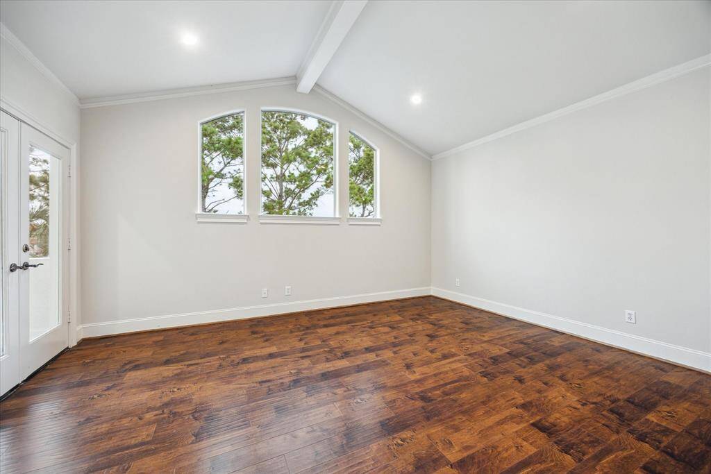 This upstairs bedroom offers direct access to the balcony overlooking the lake—perfect for enjoying fresh air and morning sun.
