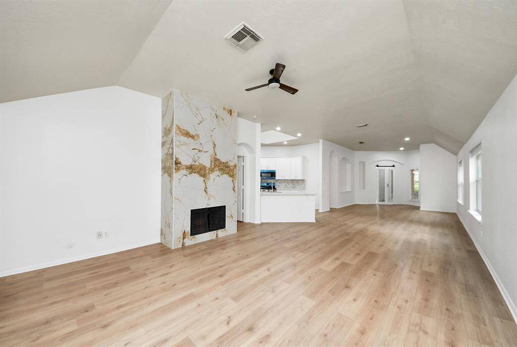 Stunning fireplace design making it a focal point in the living room.. Home has an abundance of natural sunlight.
