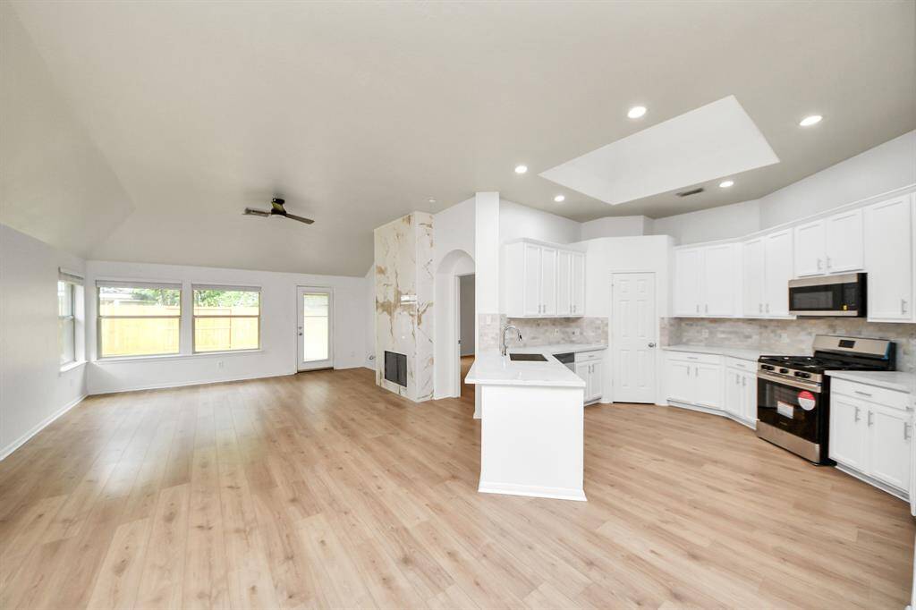 NEW Kitchen : Quartz counters, farmhouse sink, handles installed on the cabinets, new backsplash, new range, new dishwasher & new microwave.