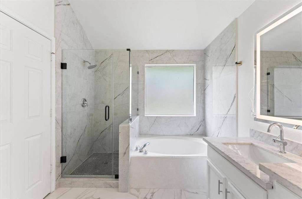 A complete bathroom remodel featuring brand-new flooring, tub, upgraded shower fixtures , handles on cabinets, Quartz countertops, a fresh sink, and all-new plumbing hardware. Plus don’t miss those stunning mirrors!