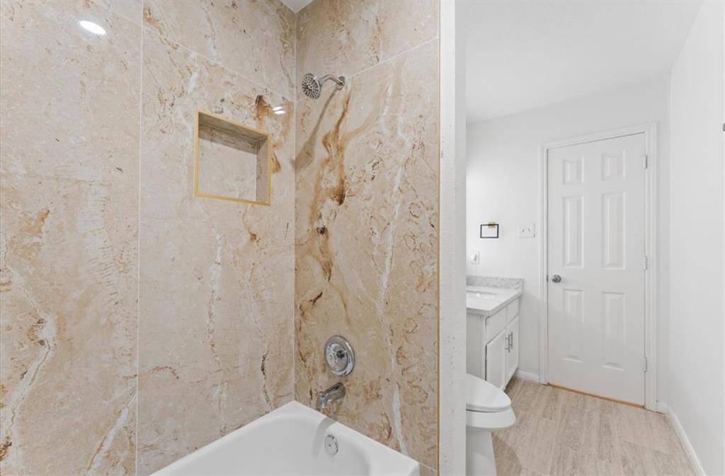 Remodeled bathrooms with large floor and wall tiles.