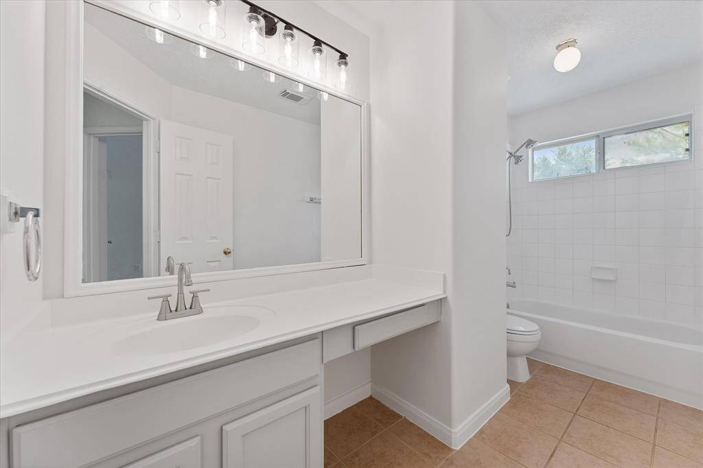 A third full bathroom with shower stand up shower and tub.