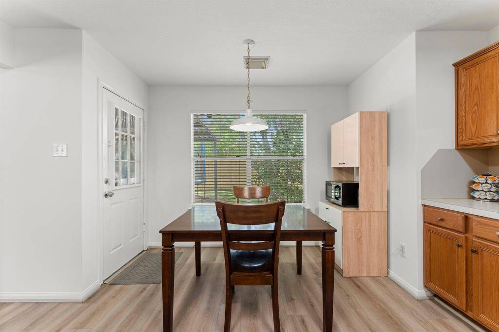 Casual dining area has great pendant light and large window overlooking backyard.