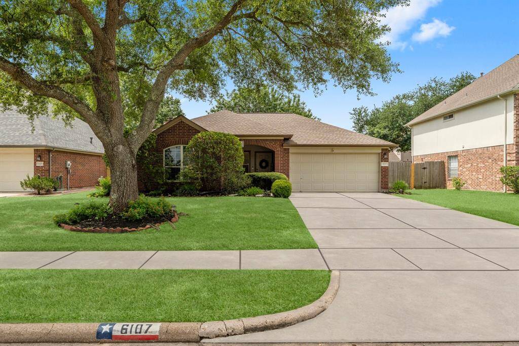 Beautiful curb appeal with green lawn and gorgeous oak tree lends to the welcoming feel of this home.