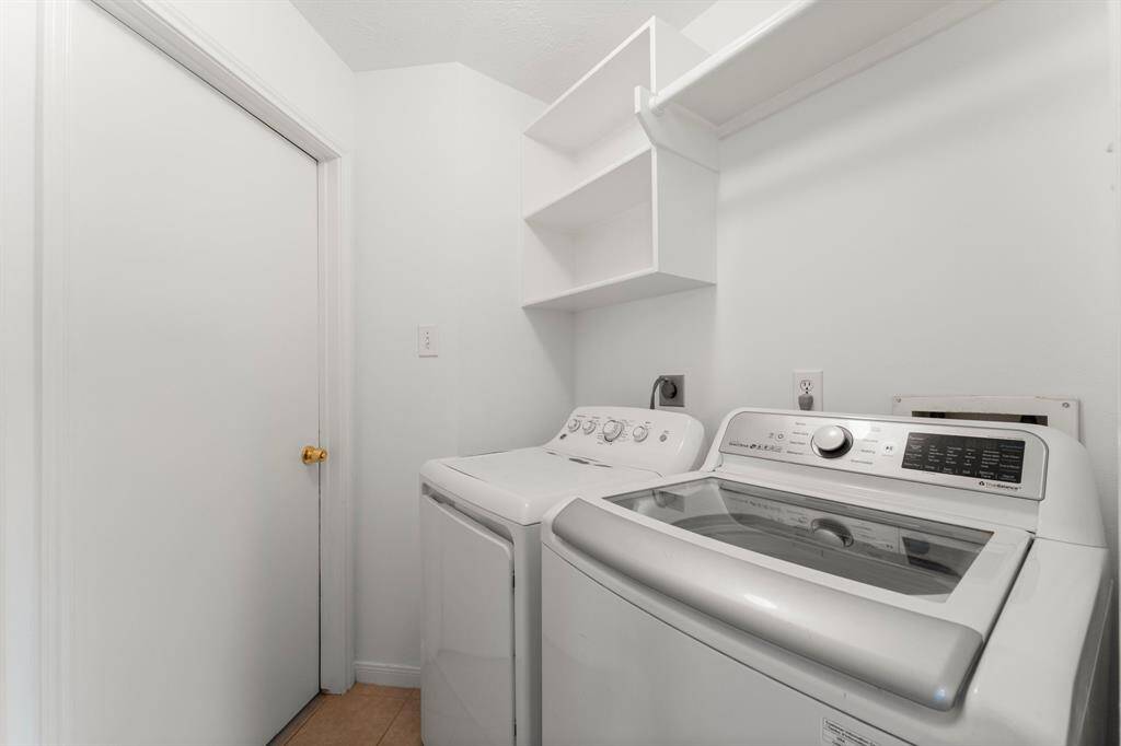 Laundry room with storage shelves.