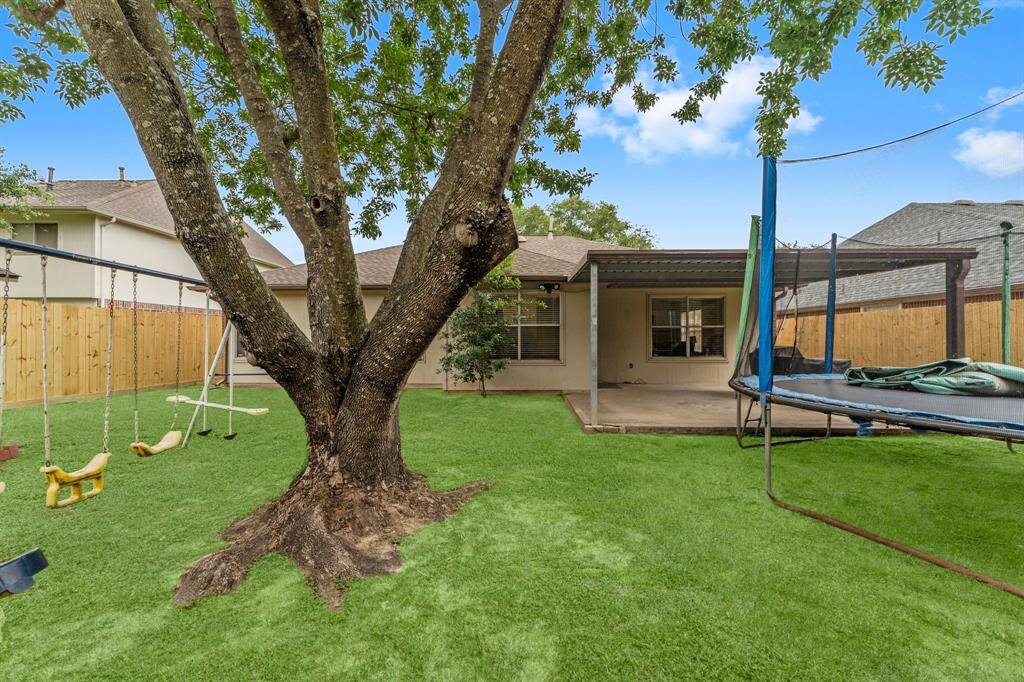 Awesome backyard with gorgeous oak tree.