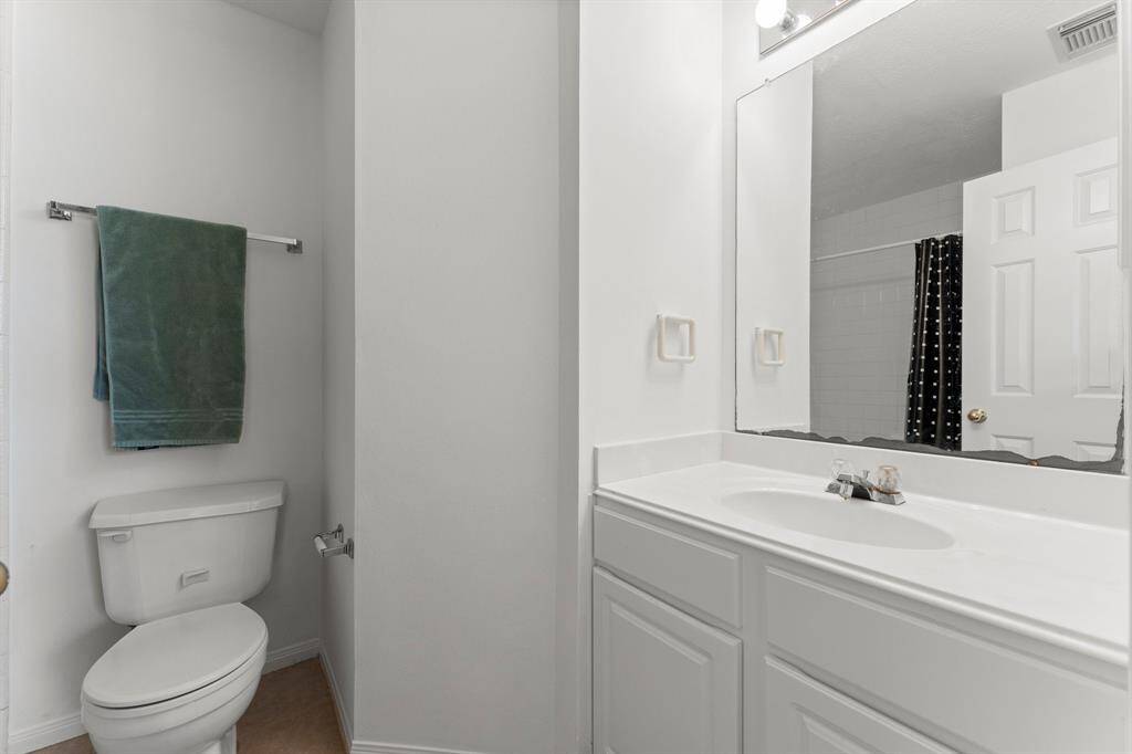 Main bathroom off hallway is for bedrooms 2 and 3 to share. It's a light and bright and has single vanity.