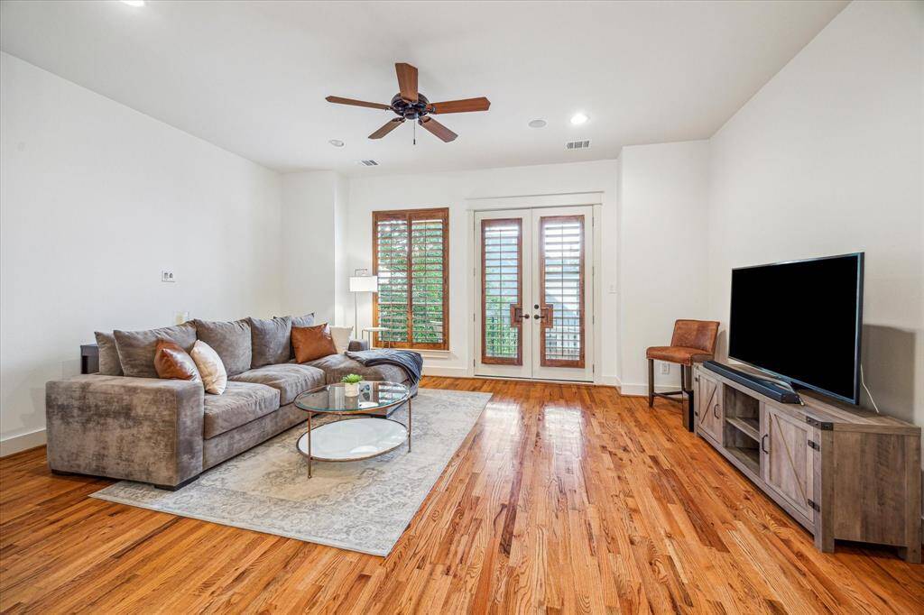 Large living room with small patio overlooking the backyard