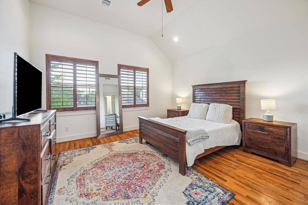 Upstairs landing showing hardwood flooring leading to the primary suite