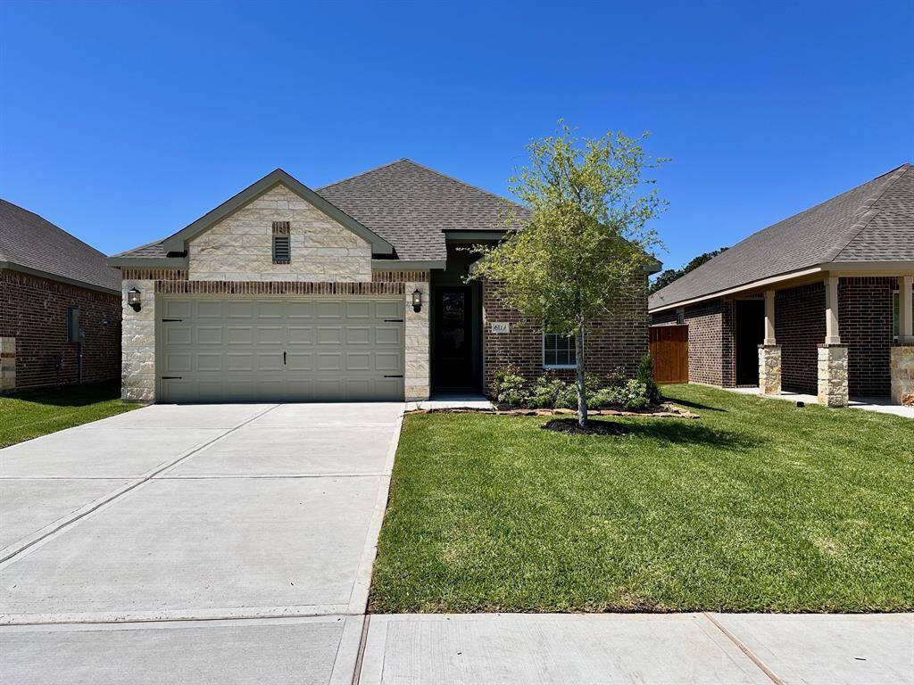 Imagine pulling into the driveway of this beautiful one-story home with coach lights and a gorgeous stone design.