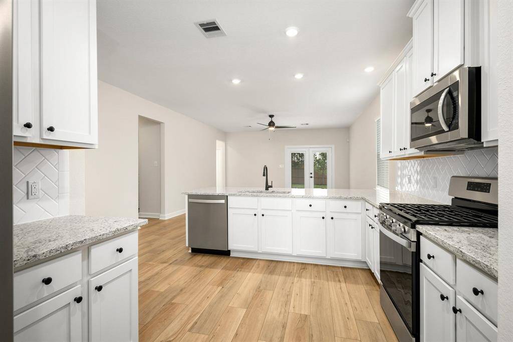 The kitchen cabinets are upgraded and painted, and the appliances are brand new, stainless steel, Whirlpool appliances.