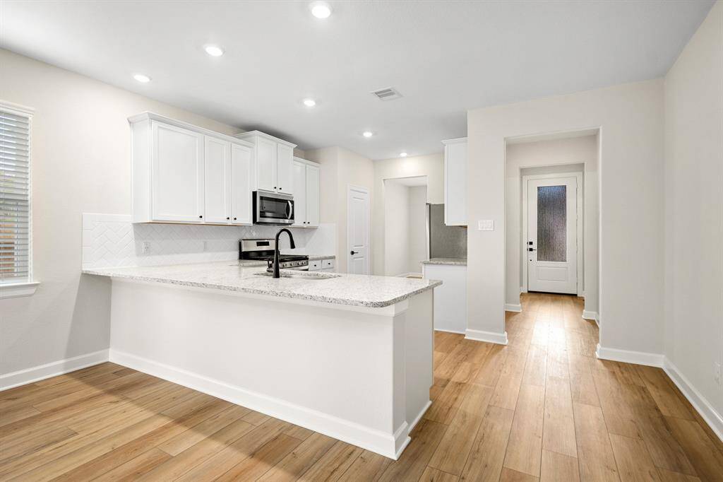 This breakfast bar will perfectly fit barstools for entertaining and socializing.