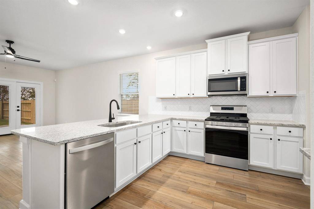 The kitchen cabinets are upgraded and painted, and the appliances are brand new, stainless steel, Whirlpool appliances.