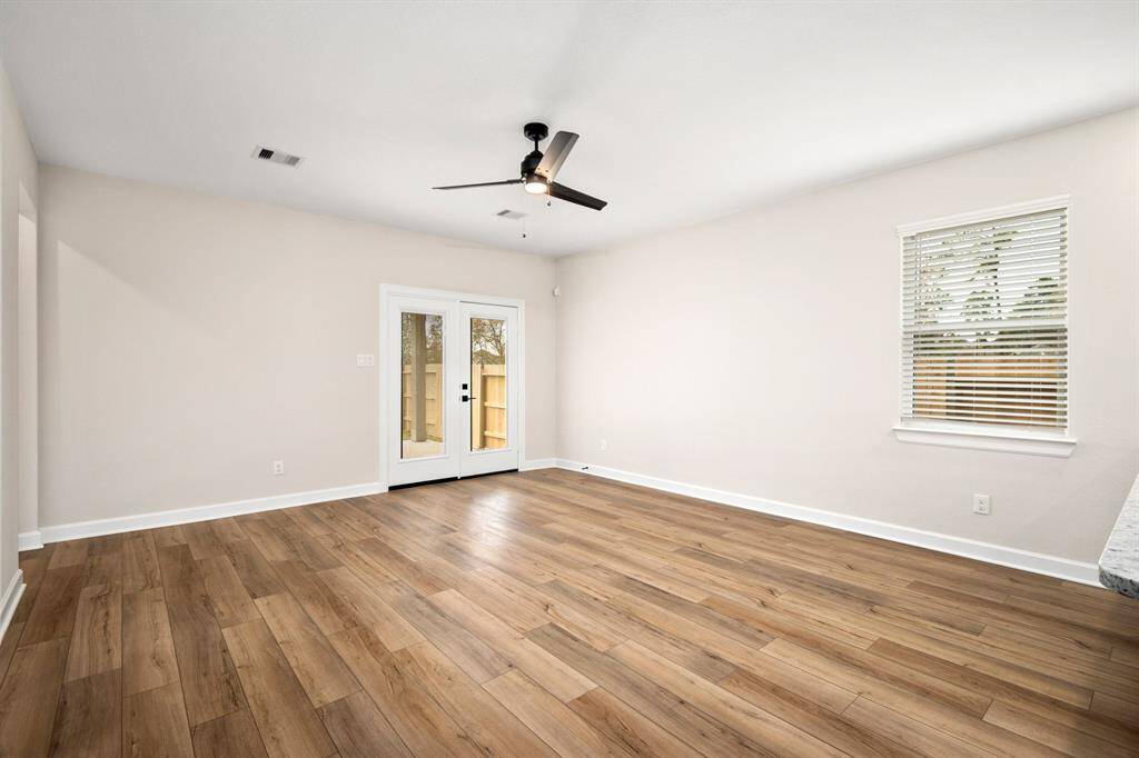 Look at the natural light and gorgeous vinyl plank floors in the living room.