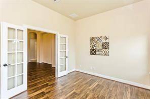 The private study/office features beautiful flooring and french doors