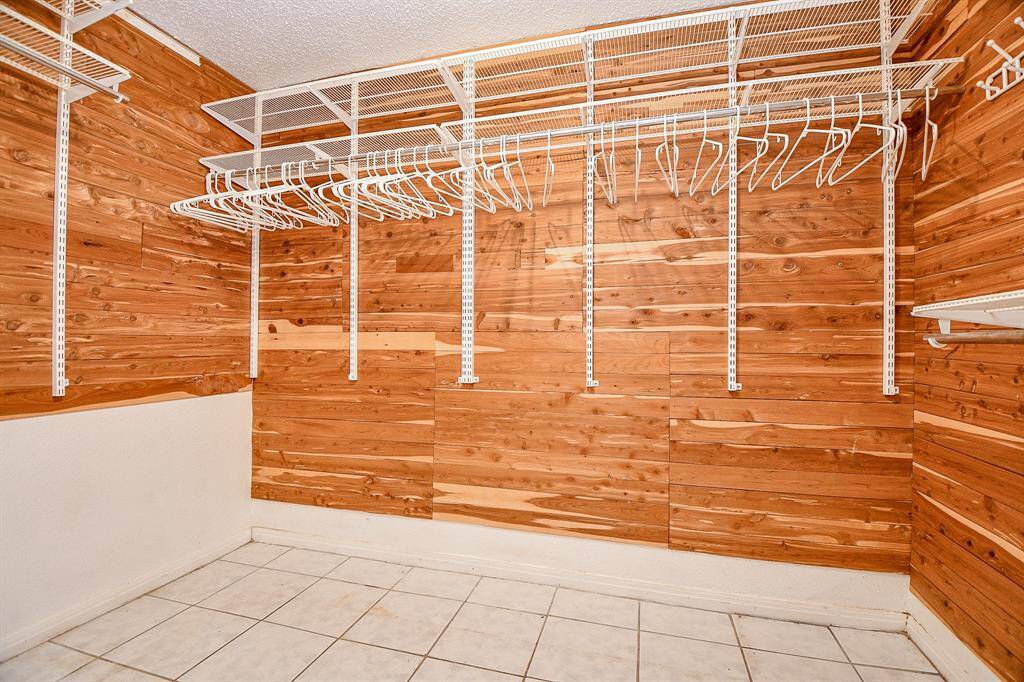 The walk in closet has been lined with cedar plank and has adjustable shelving.