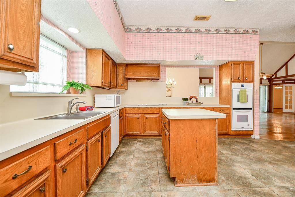 There is a lot of counter space in the kitchen. The cabinets are wood. The countertops are a neutral laminate. Tile flooring is easy to maintain.