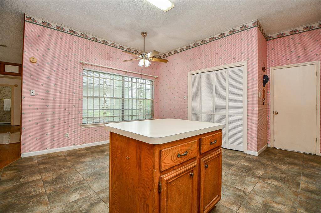 By the window is a space underneath the fan for a good sized table. Behind the louvered doors is a washer and dryer.