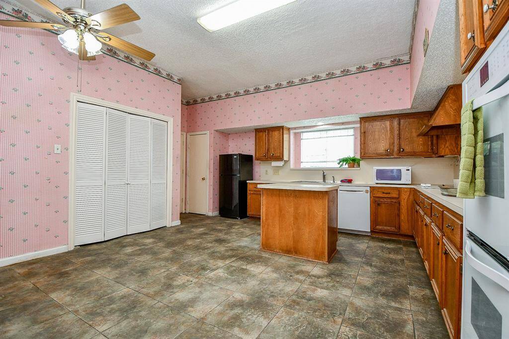 The door to the left of the refrigerator is a pantry. And to the left of that is the garage entrance, perfect for bringing in groceries.