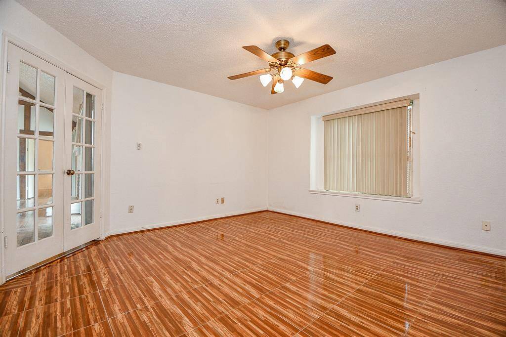 This study is off of the family room. It has wood look tile floors. There is no closet in here, but with an armoire, it could suffice as a 4th bedroom if needed.