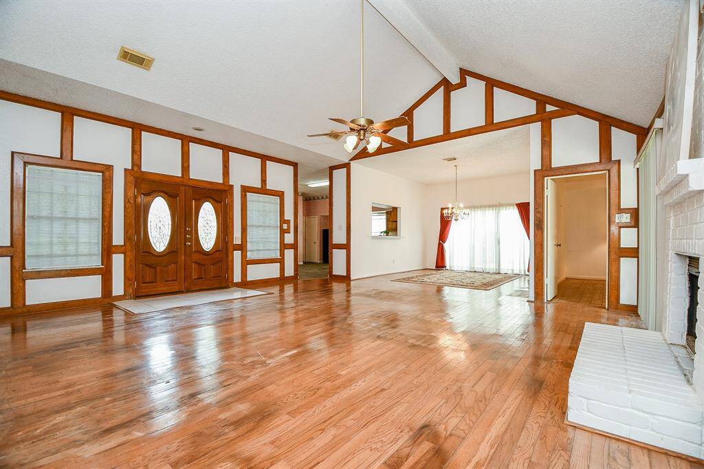To right of the front doors is the entrance to the kitchen. The window over the bar is the perfect pass through from the kitchen to the dining room.