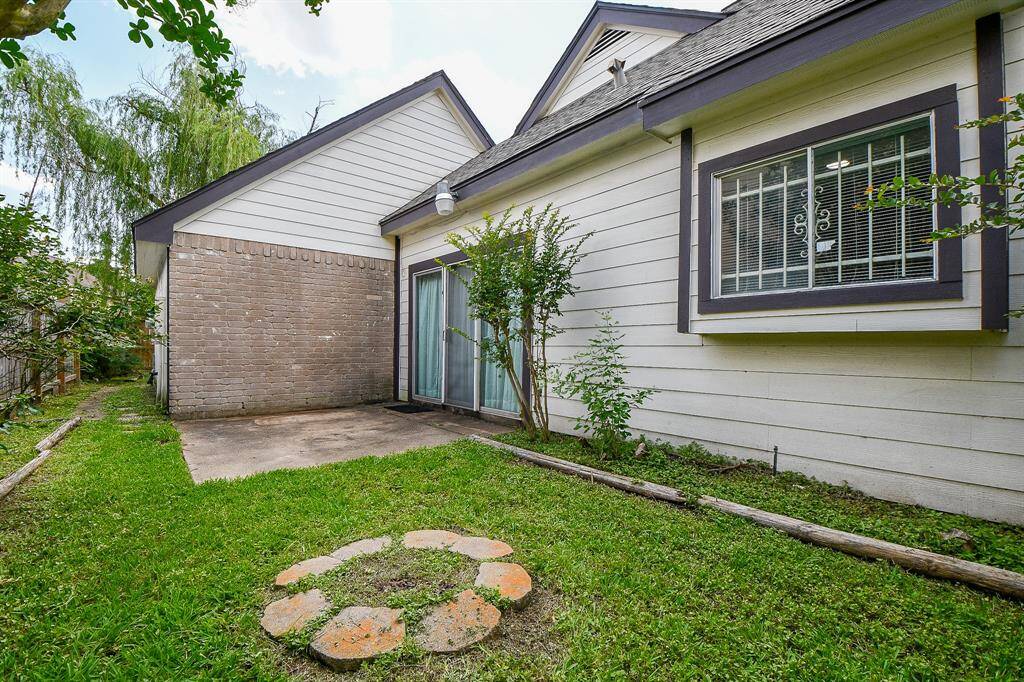 The patio area and side yard off of the dining room.