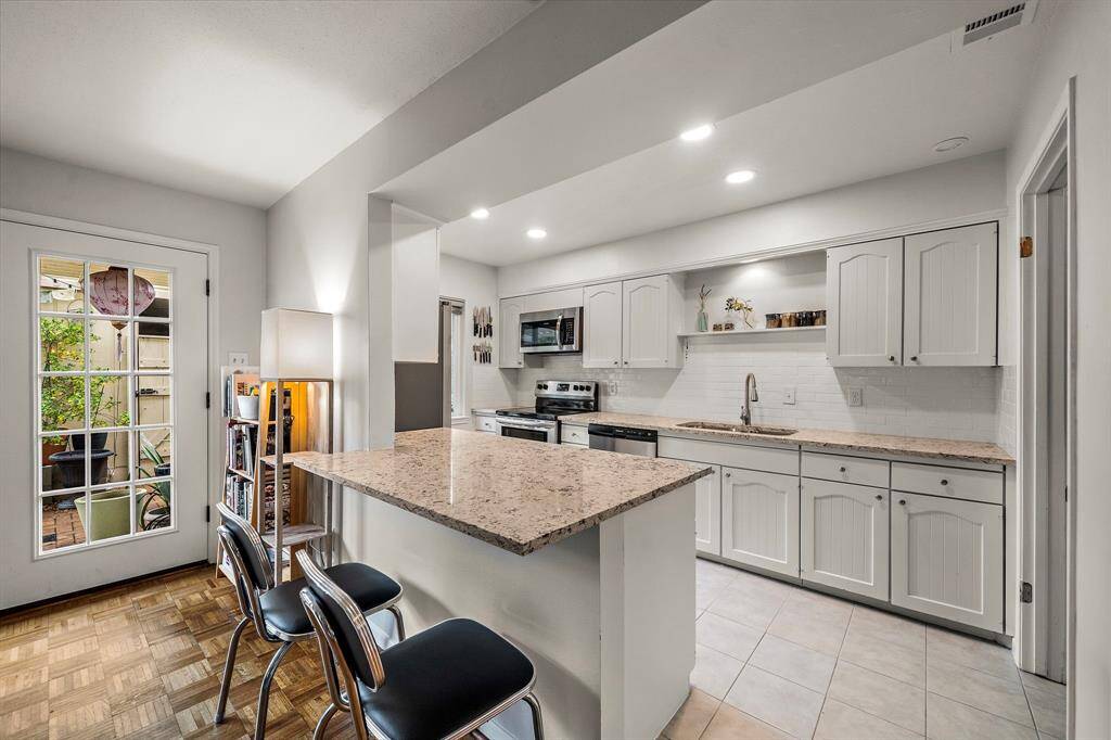Welcome to your new kitchen. It is bright, filled with natural light. It has been renovated with elegant subway tiles and timeless quartz countertops. The cabinets are hardwood. Ideal working triangle with ample countertop space and lots of storage. This kitchen is heaven for anyone who likes to cook and entertain.