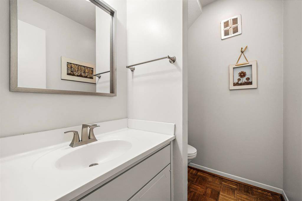 The powder room is conveniently located between the family room and dining/kitchen area.