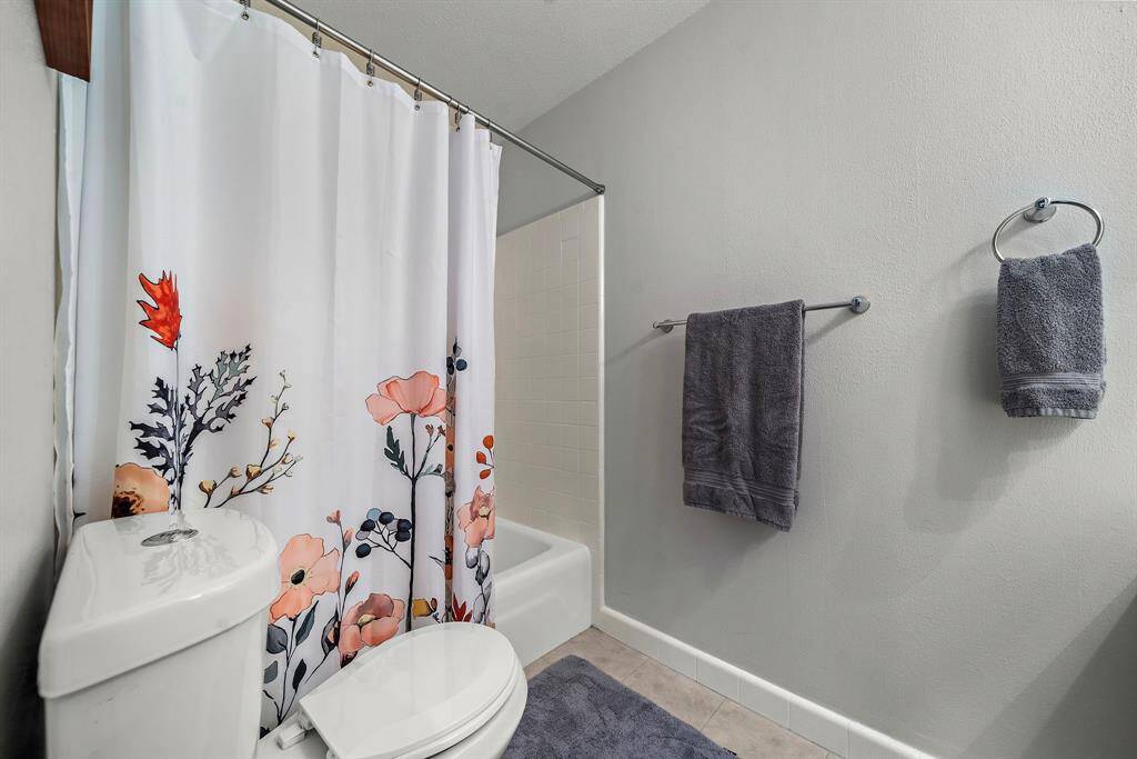 The secondary bedrooms share this full bath with a tub.