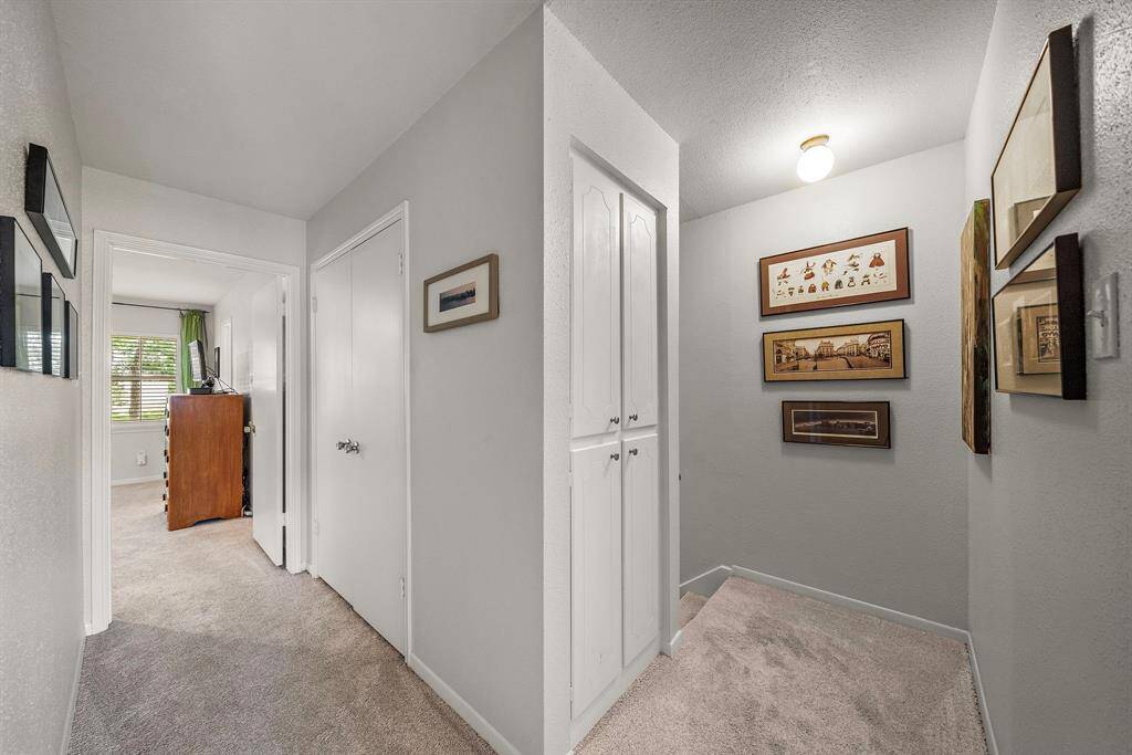 Hallway upstairs with additional storage. This home was designed to use the space efficiently.