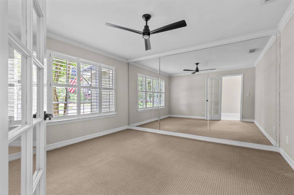 Front room serves as a flex room, exercise room, dance room, or office with a wall of mirrors, and lots of natural light